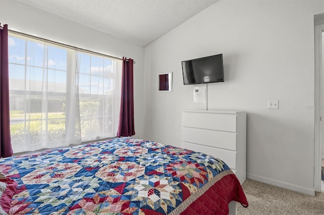 carpeted bedroom featuring a textured ceiling, baseboards, and lofted ceiling