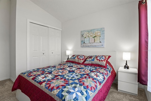 bedroom with carpet floors, baseboards, a closet, and lofted ceiling