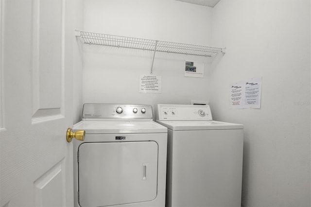 laundry room featuring washing machine and clothes dryer and laundry area