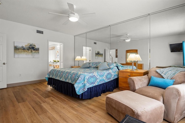 bedroom featuring light wood-type flooring, ceiling fan, baseboards, and visible vents