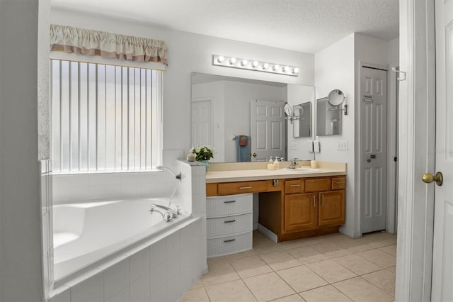 full bath with a garden tub, vanity, tile patterned flooring, and a healthy amount of sunlight