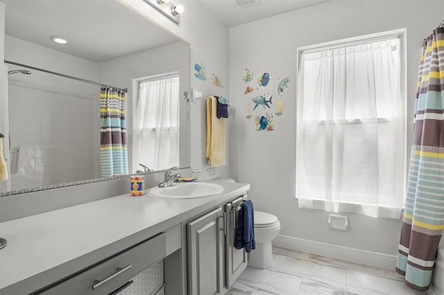 full bathroom with vanity, a shower with curtain, toilet, marble finish floor, and baseboards