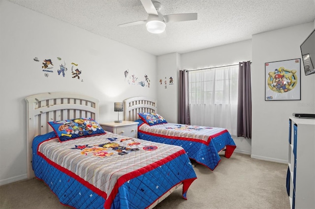 carpeted bedroom featuring baseboards, a textured ceiling, and a ceiling fan