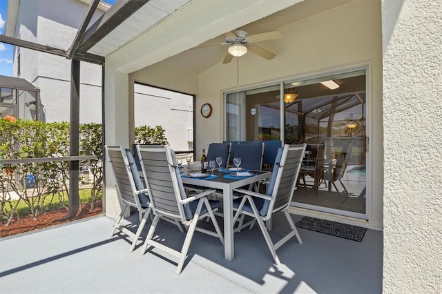 sunroom / solarium featuring ceiling fan and outdoor dining area