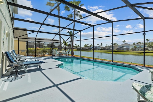 outdoor pool featuring a water view, a patio, and a lanai