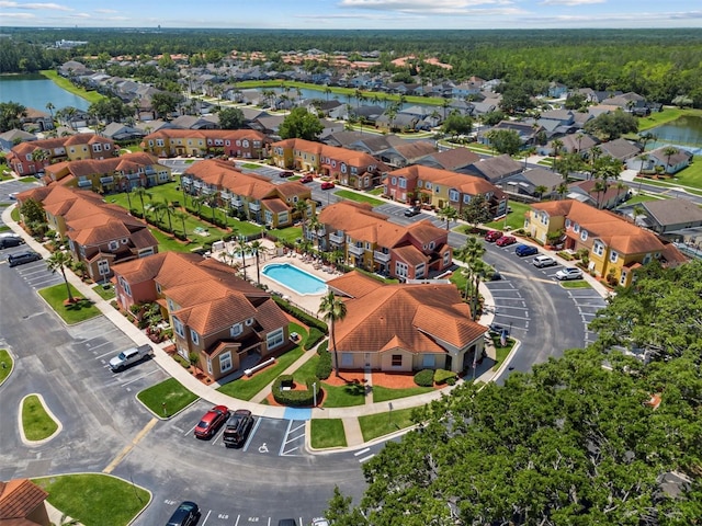 birds eye view of property featuring a water view and a residential view