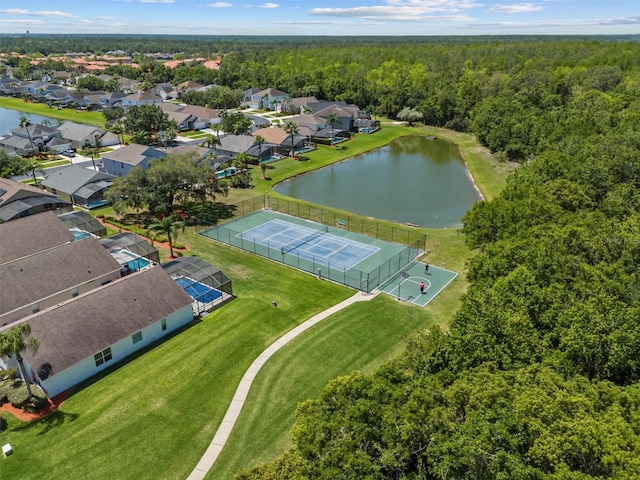 aerial view featuring a wooded view and a water view