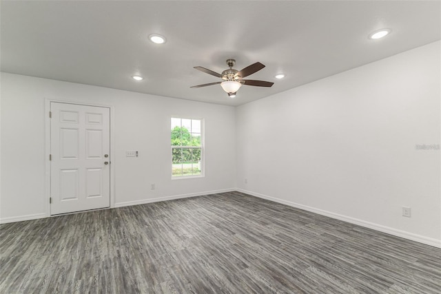 empty room featuring recessed lighting, dark wood finished floors, a ceiling fan, and baseboards