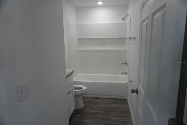 bathroom with shower / washtub combination, wood finished floors, vanity, and toilet