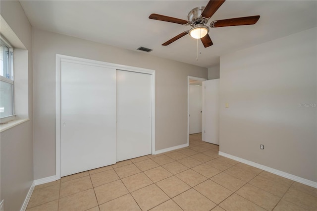 703 Osceola Ave, Lake Wales, FL 33853 - unfurnished bedroom featuring baseboards, visible vents, a ceiling fan, a closet, and light tile patterned floors