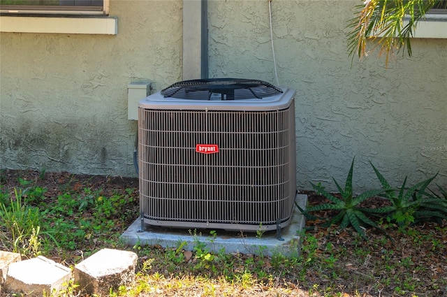 703 Osceola Ave, Lake Wales, FL 33853 - details with cooling unit and stucco siding