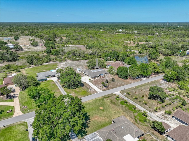 drone / aerial view featuring a forest view
