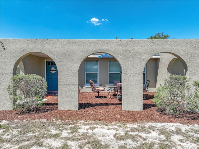 property entrance with stucco siding