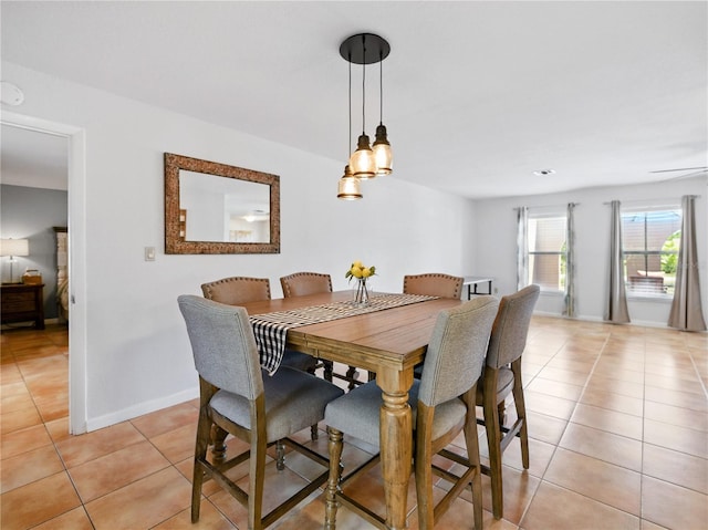 dining room featuring baseboards and light tile patterned floors