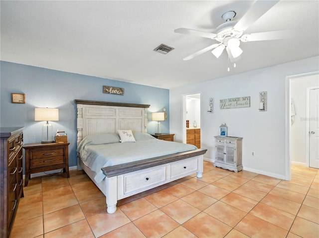 bedroom with visible vents, connected bathroom, ceiling fan, and light tile patterned flooring