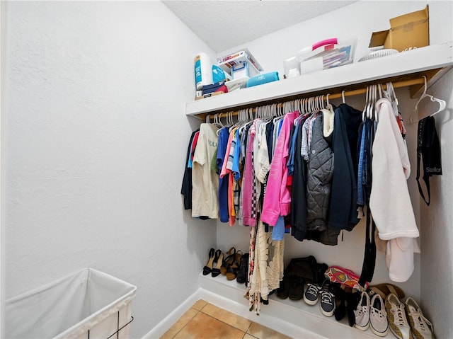walk in closet with tile patterned floors