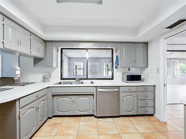 kitchen with gray cabinetry, stainless steel appliances, visible vents, and a sink