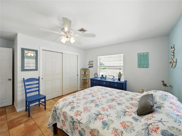 bedroom with visible vents, a closet, ceiling fan, and light tile patterned floors