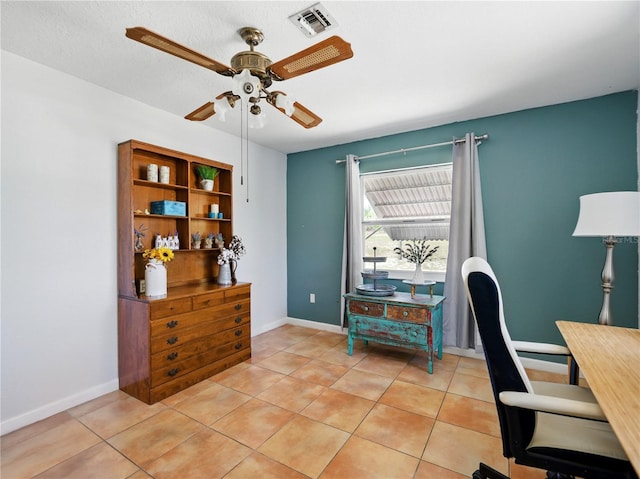 home office featuring baseboards, a ceiling fan, visible vents, and light tile patterned flooring