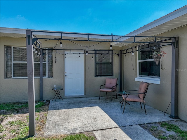back of property with a patio area and stucco siding