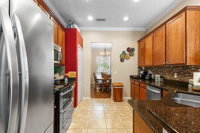 177 Costa Loop, Auburndale, FL 33823 - kitchen with stainless steel appliances, tasteful backsplash, a chandelier, crown molding, and a textured ceiling