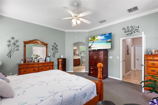 177 Costa Loop, Auburndale, FL 33823 - carpeted bedroom with arched walkways, crown molding, baseboards, connected bathroom, and ceiling fan