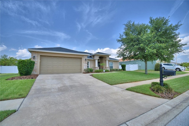 186 Viola Dr, Auburndale, FL 33823 - view of front of house featuring stone siding, driveway, a garage, and stucco siding