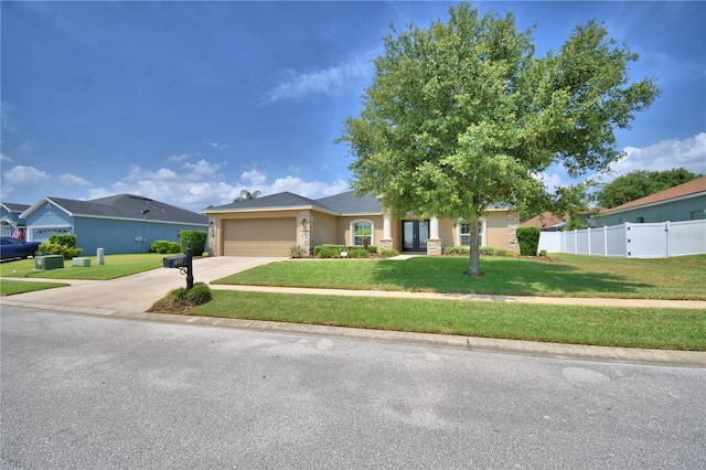 186 Viola Dr, Auburndale, FL 33823 - view of front of home with an attached garage, concrete driveway, and stone siding