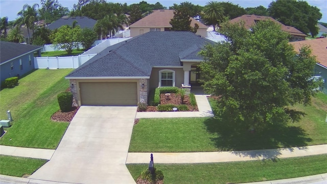 186 Viola Dr, Auburndale, FL 33823 - view of front of home with an attached garage, roof with shingles, driveway, stucco siding, and a residential view