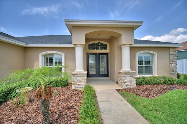 186 Viola Dr, Auburndale, FL 33823 - property entrance with french doors, stucco siding, stone siding, and a shingled roof