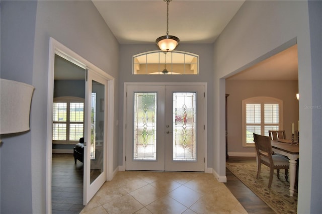 186 Viola Dr, Auburndale, FL 33823 - tiled foyer entrance with french doors, plenty of natural light, and baseboards