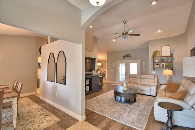 186 Viola Dr, Auburndale, FL 33823 - living area with ceiling fan, baseboards, dark wood-style flooring, arched walkways, and vaulted ceiling