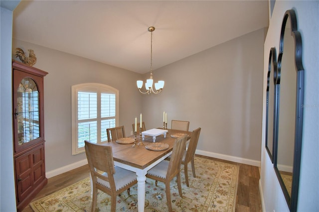 186 Viola Dr, Auburndale, FL 33823 - dining area with a chandelier, light wood-style flooring, and baseboards