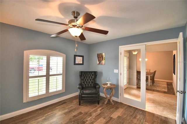 186 Viola Dr, Auburndale, FL 33823 - living area with dark wood-type flooring, ceiling fan, and baseboards