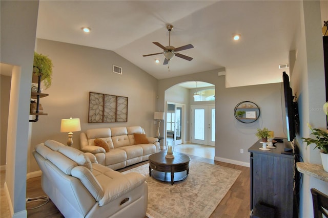 186 Viola Dr, Auburndale, FL 33823 - living room with arched walkways, ceiling fan, vaulted ceiling, wood finished floors, and baseboards