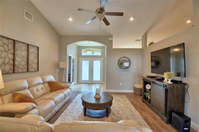 186 Viola Dr, Auburndale, FL 33823 - living area with arched walkways, baseboards, wood finished floors, a ceiling fan, and french doors