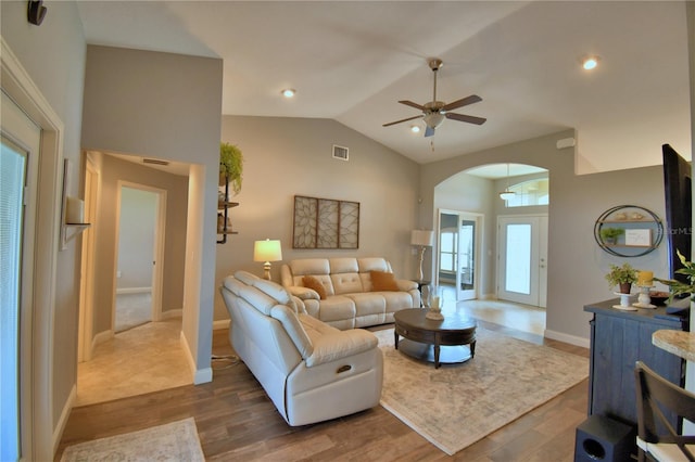 186 Viola Dr, Auburndale, FL 33823 - living area featuring arched walkways, ceiling fan, lofted ceiling, wood finished floors, and baseboards