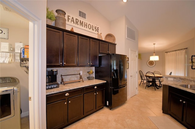 186 Viola Dr, Auburndale, FL 33823 - kitchen with washer / clothes dryer, black refrigerator with ice dispenser, dark brown cabinets, backsplash, and light tile patterned floors