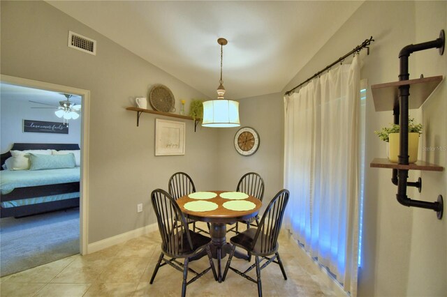 186 Viola Dr, Auburndale, FL 33823 - dining room with lofted ceiling, light tile patterned floors, light carpet, a ceiling fan, and baseboards