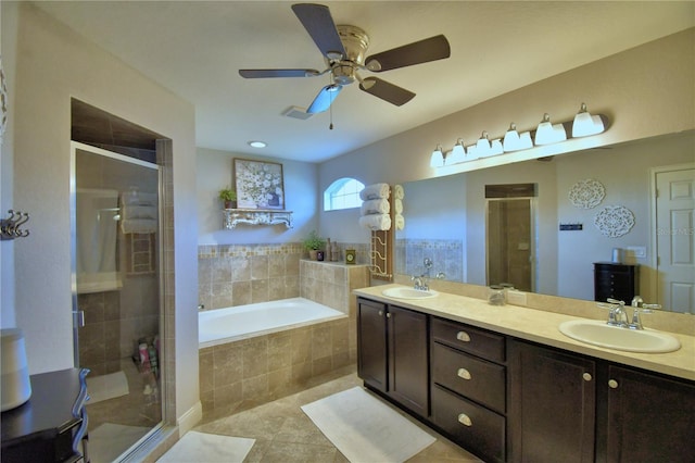 186 Viola Dr, Auburndale, FL 33823 - full bath featuring a shower stall, a garden tub, tile patterned floors, double vanity, and a ceiling fan