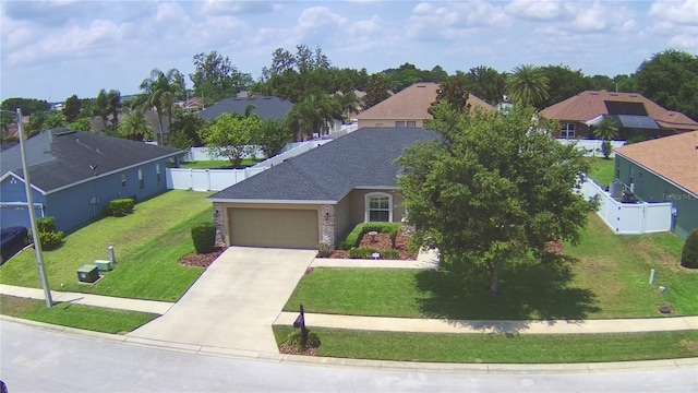 186 Viola Dr, Auburndale, FL 33823 - view of front of home featuring a garage, driveway, a residential view, and stone siding