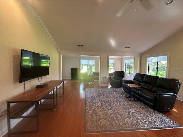 living room with lofted ceiling, visible vents, crown molding, and wood finished floors