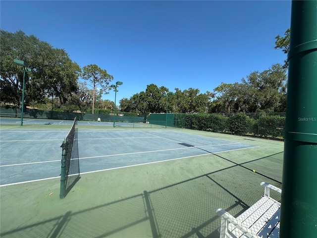 view of sport court featuring fence