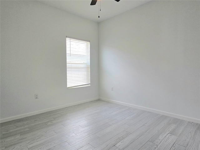 625 Disa Dr, Davenport, FL 33837 - spare room with a ceiling fan, light wood-style floors, and baseboards
