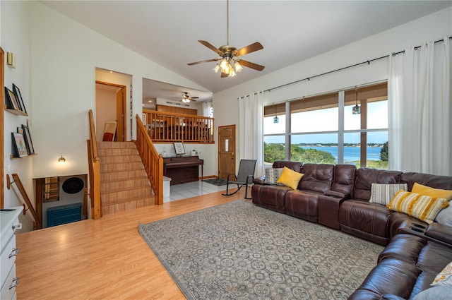 2390 Lake Easy Rd, Babson Park, FL 33827 - living area featuring a ceiling fan, vaulted ceiling, wood finished floors, stairway, and a water view