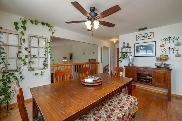 2390 Lake Easy Rd, Babson Park, FL 33827 - dining room with wood-type flooring, baseboards, ceiling fan, and visible vents