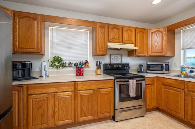 2390 Lake Easy Rd, Babson Park, FL 33827 - kitchen featuring a sink, stainless steel appliances, brown cabinets, and under cabinet range hood