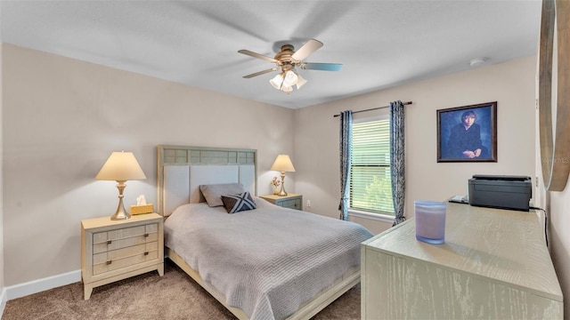 carpeted bedroom with ceiling fan and baseboards