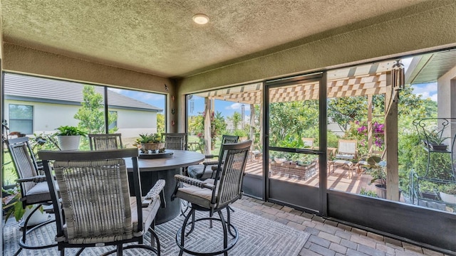 sunroom / solarium with a wealth of natural light and outdoor dining area