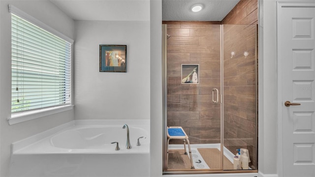 bathroom featuring a garden tub and a stall shower